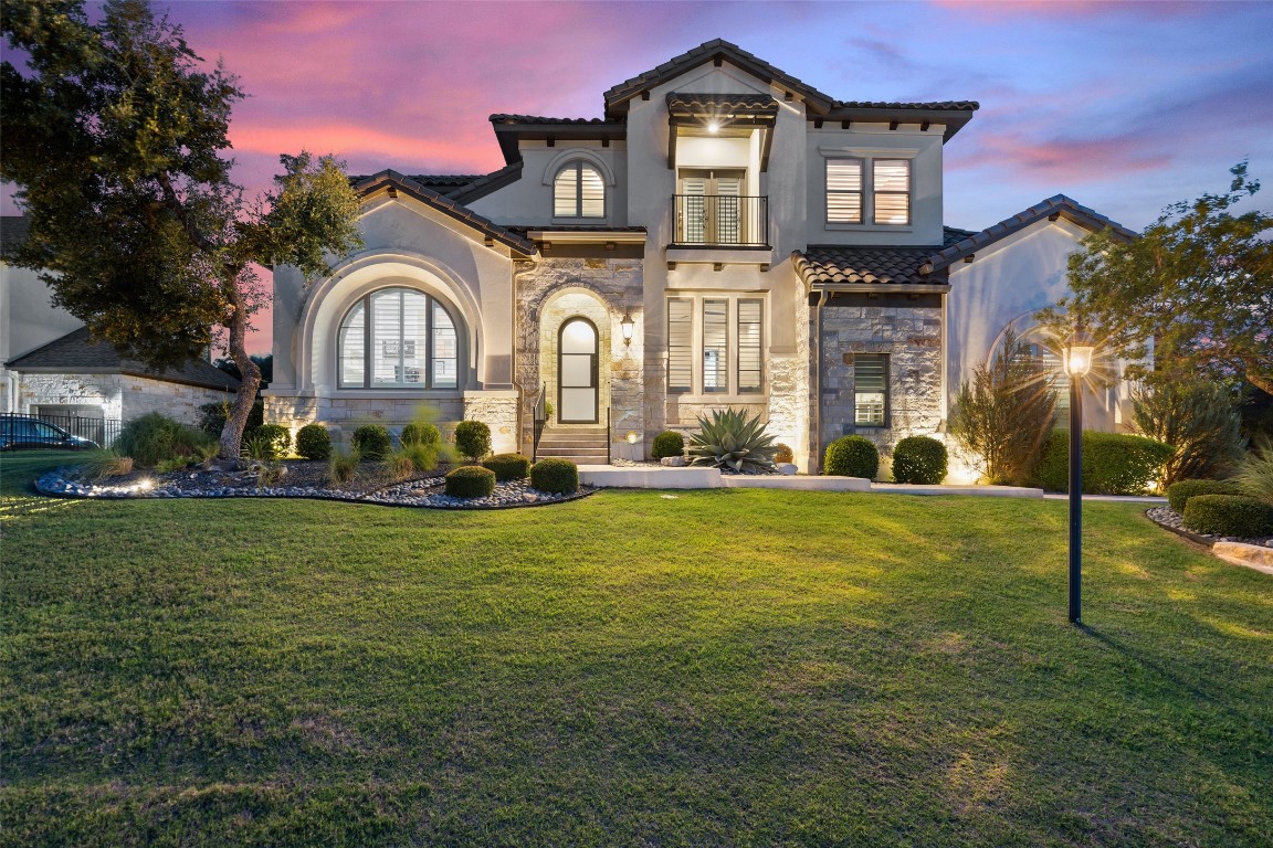 403 Woodside Terrace Austin, TX 78738 - Photo 2 of 38 a front view of a house with a garden