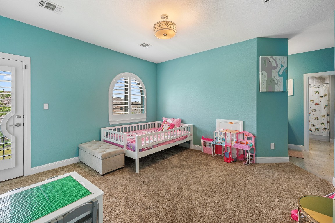 403 Woodside Terrace Austin, TX 78738 - Photo 23 of 38 a bedroom with a bed and a window