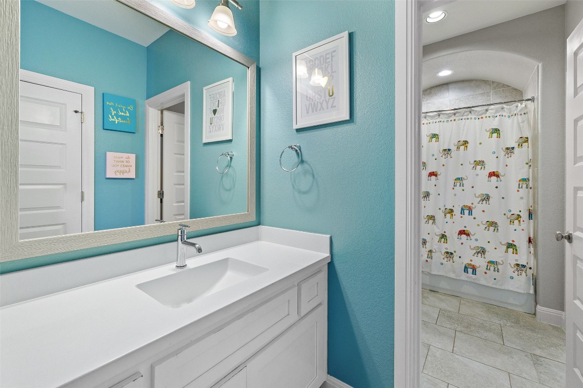 403 Woodside Terrace Austin, TX 78738 - Photo 24 of 38 a bathroom with a sink a toilet and shower