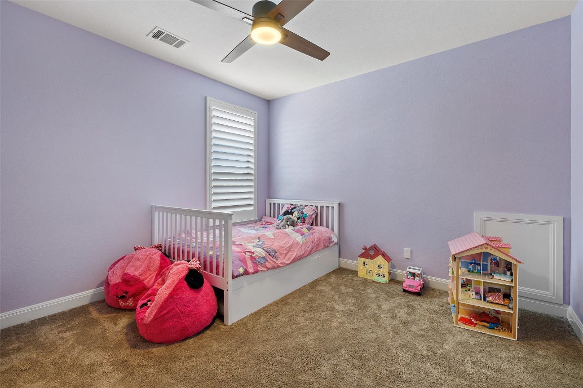 403 Woodside Terrace Austin, TX 78738 - Photo 25 of 38 a bedroom with a bed and a chandelier