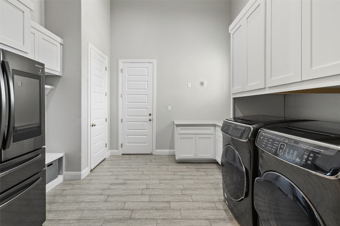 403 Woodside Terrace Austin, TX 78738 - Photo 26 of 38 a kitchen with a refrigerator and cabinets