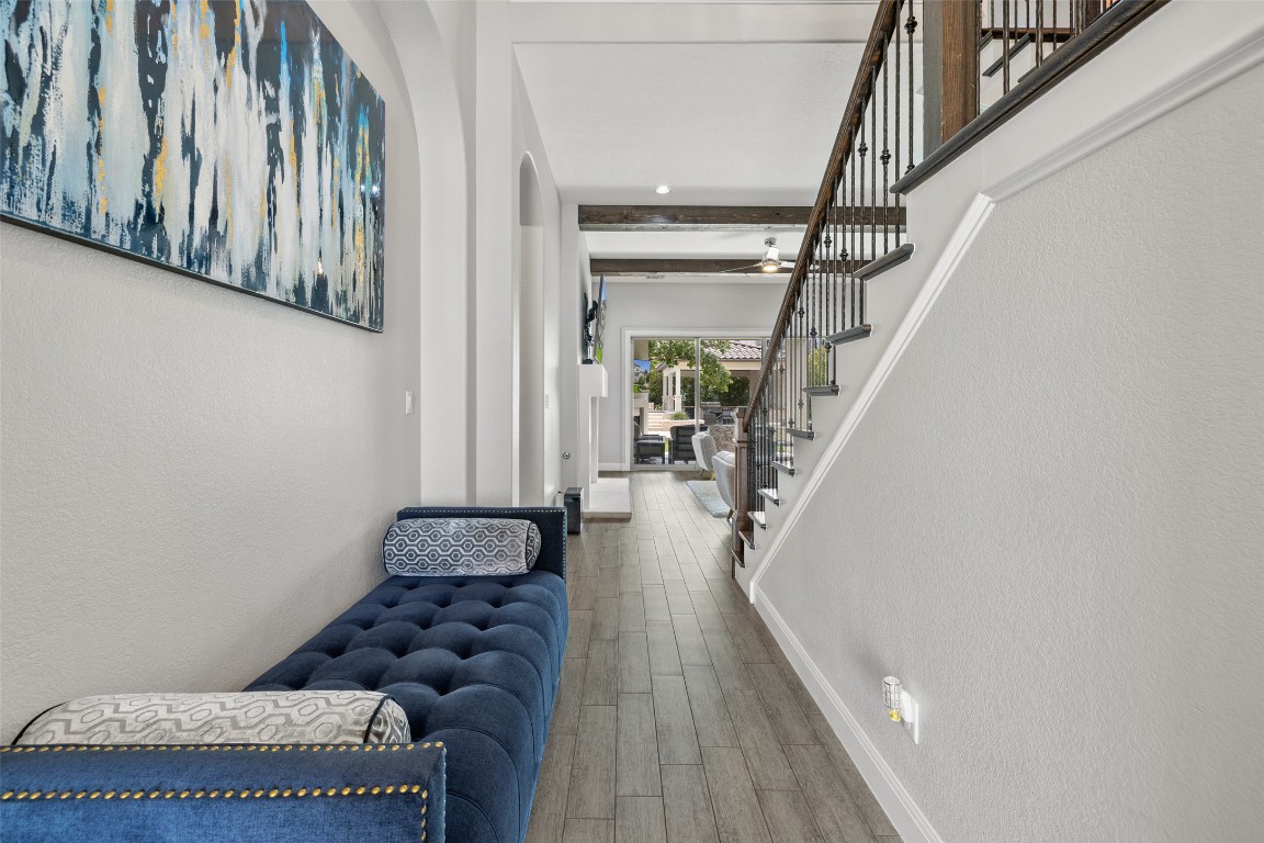 403 Woodside Terrace Austin, TX 78738 - Photo 5 of 38 Foyer entrance featuring wood finished floors, stairway, arched walkways, and a textured wall