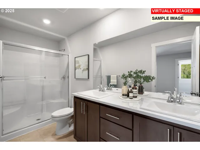 a bathroom with a sink a toilet a mirror and shower