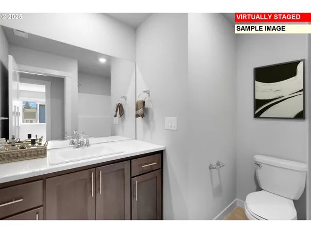 a bathroom with a sink a toilet a mirror and vanity