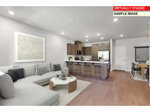 a living room with stainless steel appliances kitchen island granite countertop furniture and a view of kitchen