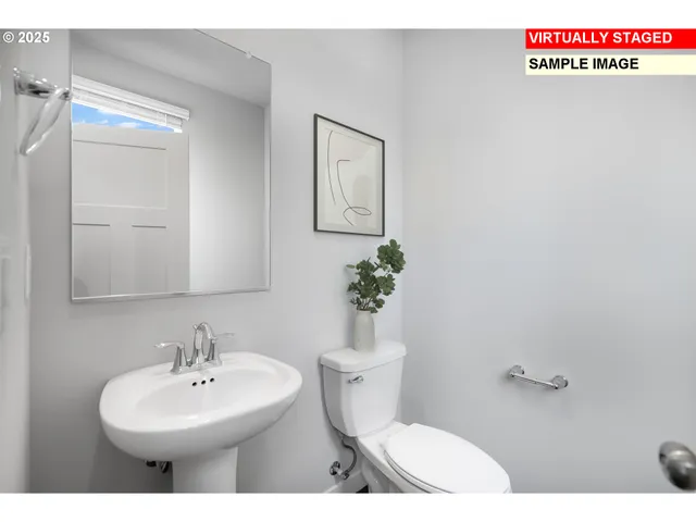 a bathroom with a sink mirror and toilet