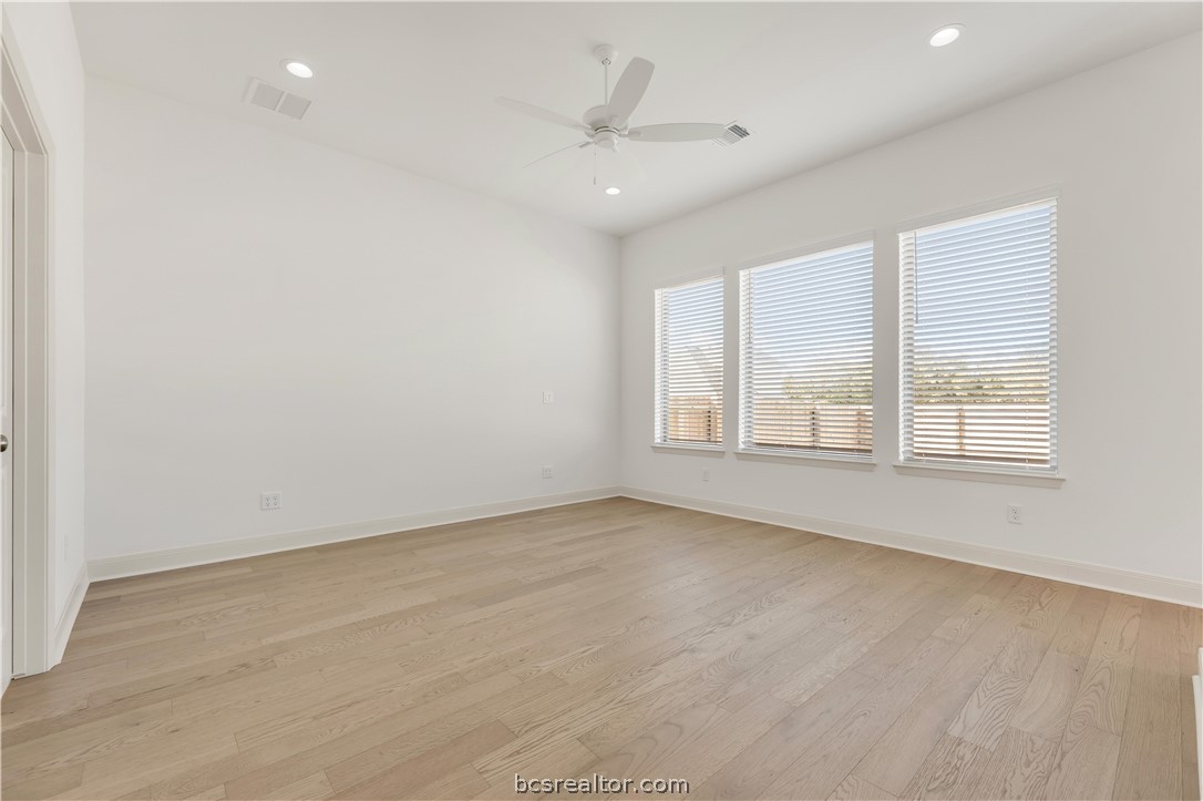 5084 Acadia Loop Bryan, TX 77802 - Photo 18 of 33 an empty room with a ceiling fan and window