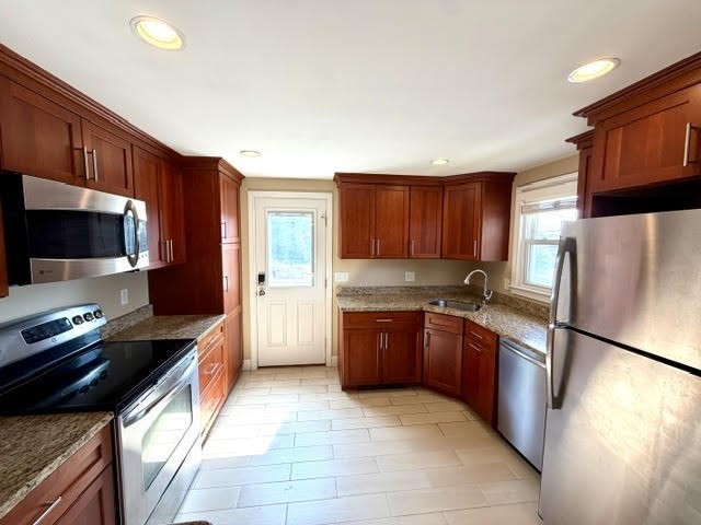116 Upton Road Waltham, MA 02452 - Photo 7 of 22 a kitchen with stainless steel appliances granite countertop a refrigerator stove a sink and dishwasher