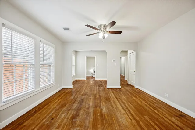 a view of a room with wooden floor and fan