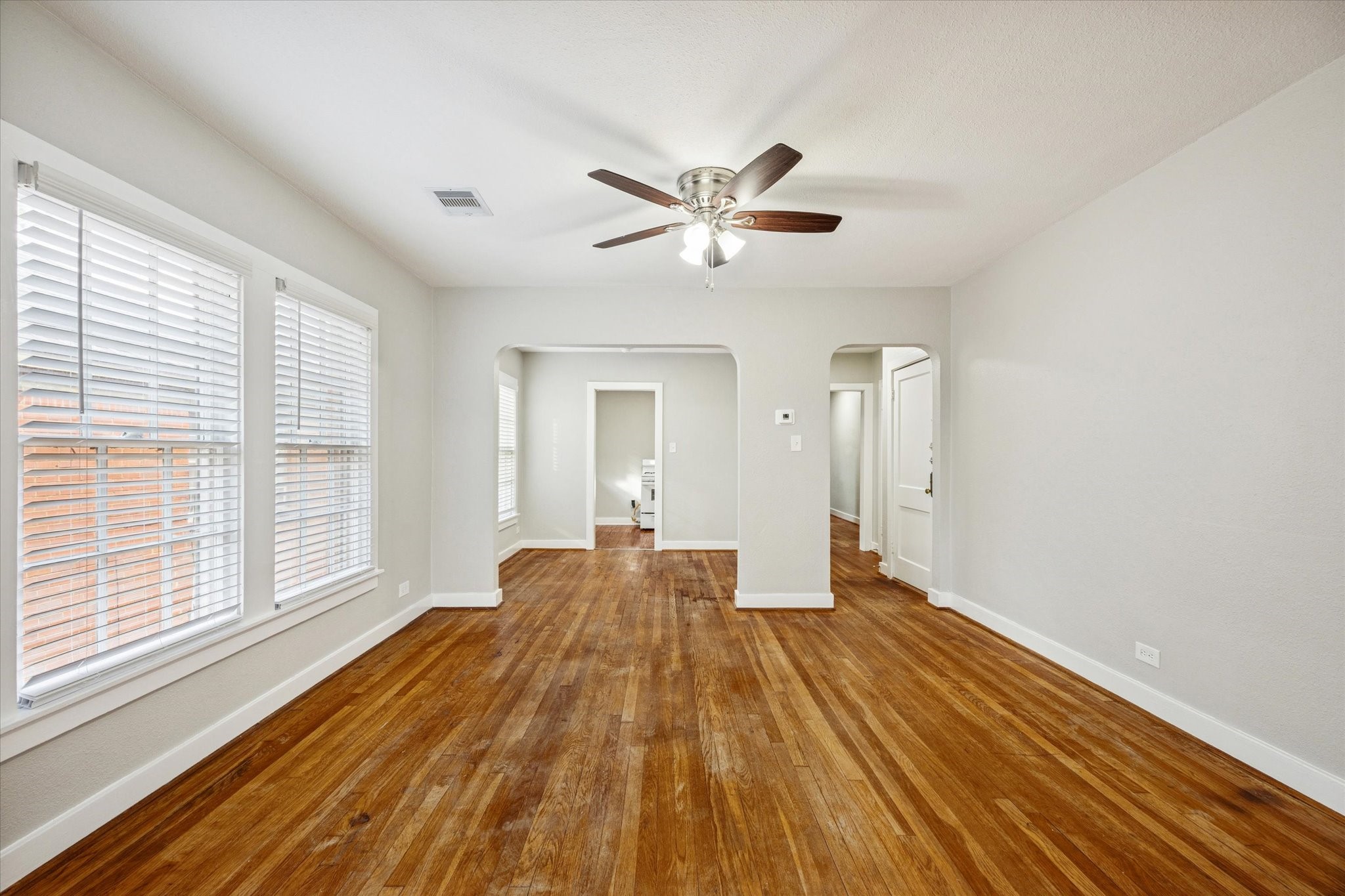 1812 West Alabama Street, Unit 4 Houston, TX 77098 - Photo 2 of 10 a view of a room with wooden floor and fan