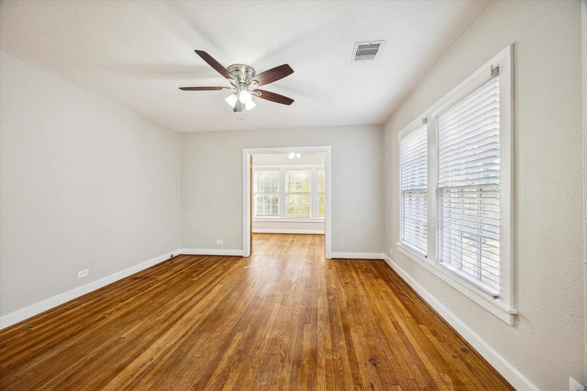 1812 West Alabama Street, Unit 4 Houston, TX 77098 - Photo 6 of 10 a view of empty room with wooden floor and fan