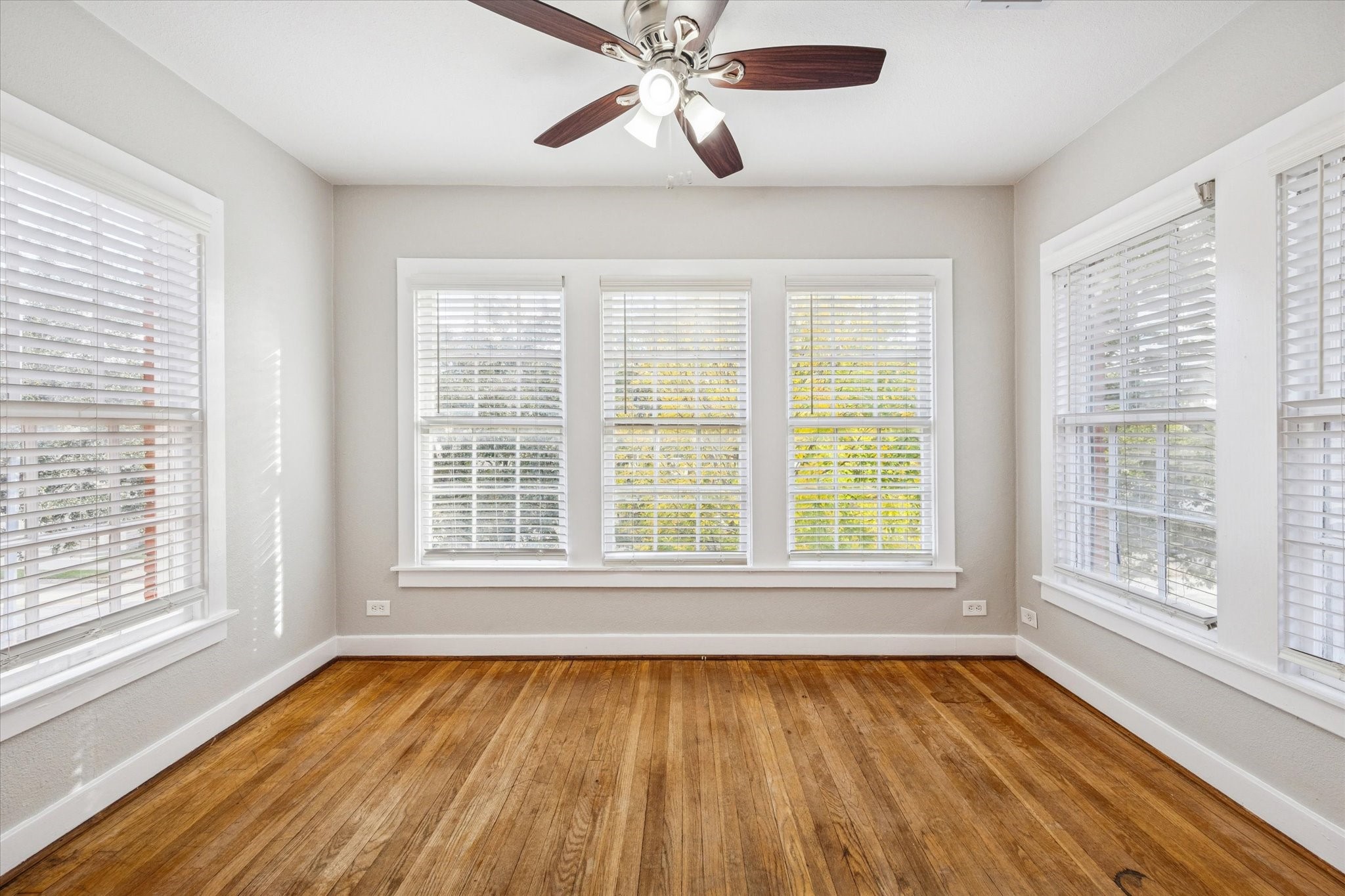 1812 West Alabama Street, Unit 4 Houston, TX 77098 - Photo 7 of 10 a view of an empty room with wooden floor and a window