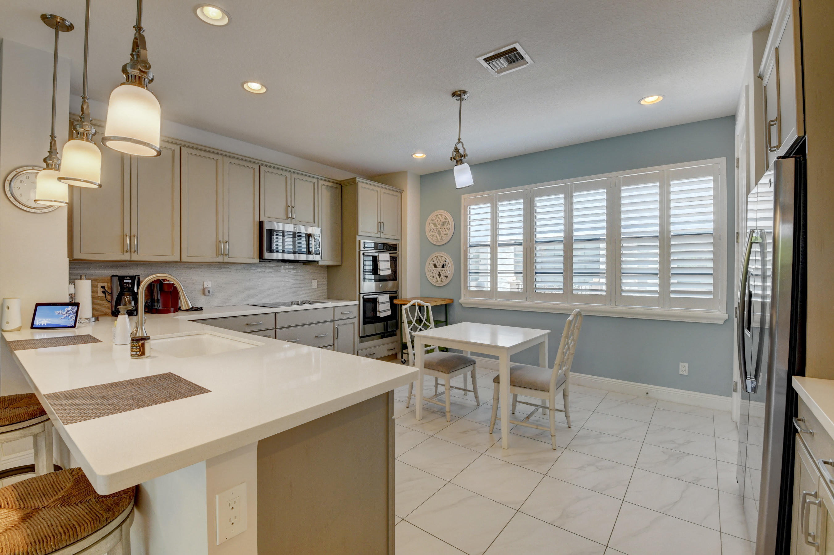 608 Windward Circle Boynton Beach, FL 33435 - Photo 3 of 42 a kitchen with a table chairs and a refrigerator