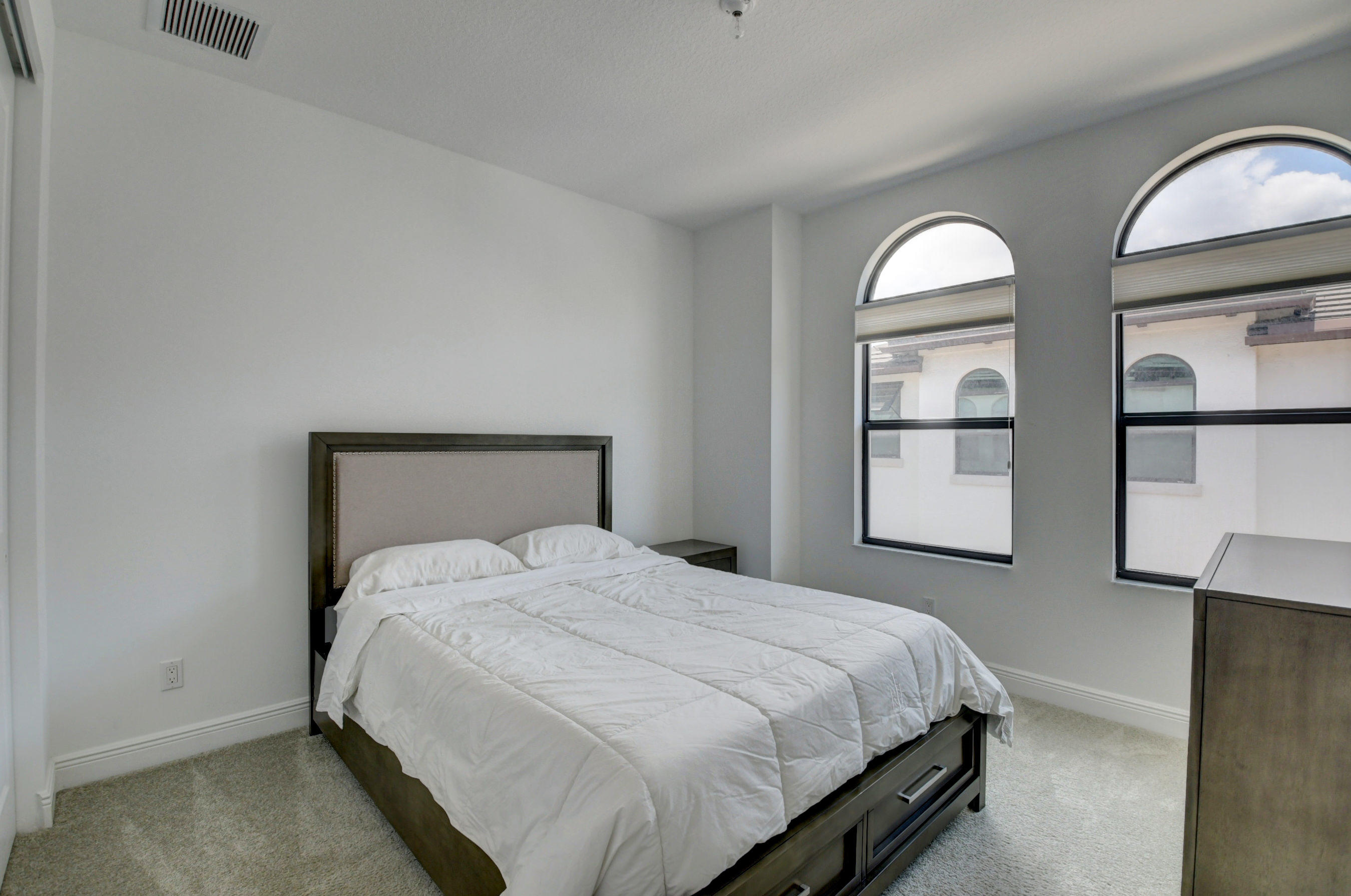 608 Windward Circle Boynton Beach, FL 33435 - Photo 23 of 42 a bedroom with a bed and a window