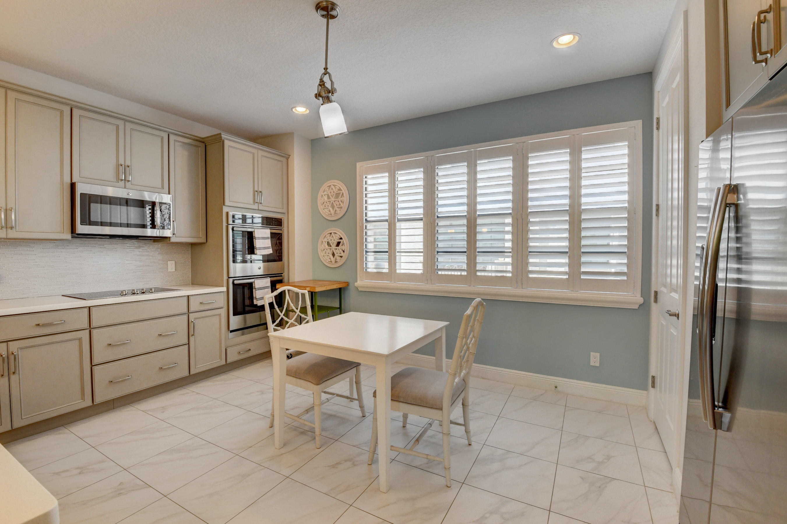 608 Windward Circle Boynton Beach, FL 33435 - Photo 6 of 42 a kitchen with stainless steel appliances granite countertop a stove a sink dishwasher a refrigerator with white cabinets and wooden floor