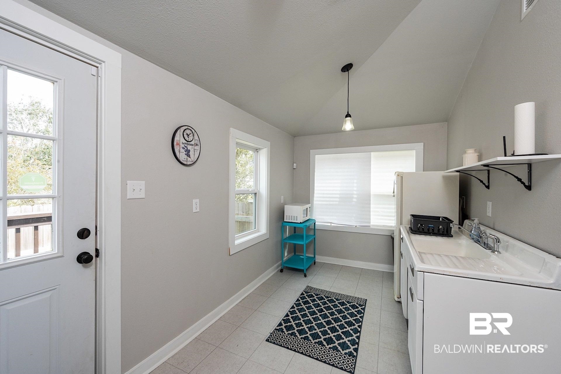 22051 Broad Street Silverhill, AL 36576 - Photo 12 of 28 Washroom with a wealth of natural light, a textured ceiling, and light tile patterned flooring
