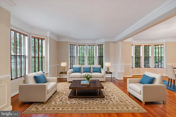 a view of empty room with wooden floor and windows