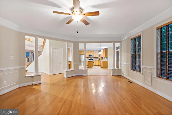 a kitchen with stainless steel appliances granite countertop a stove top oven a sink dishwasher and cabinets with wooden floor