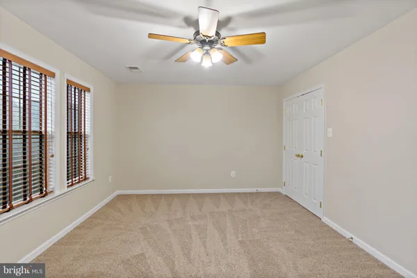a living room with furniture a flat screen tv and a window