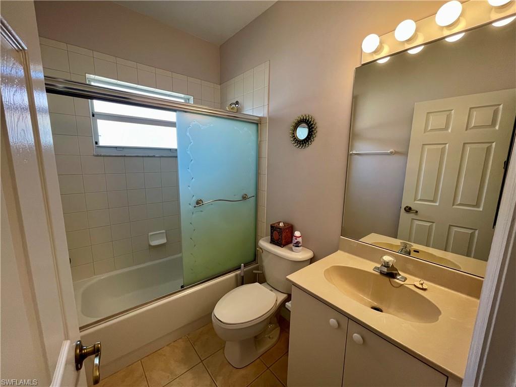 2895 Orange Grove Trail Naples, FL 34120 - Photo 11 of 33 a bathroom with a sink a toilet a mirror and shower