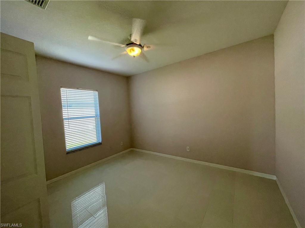 2895 Orange Grove Trail Naples, FL 34120 - Photo 16 of 33 a view of an empty room with a window