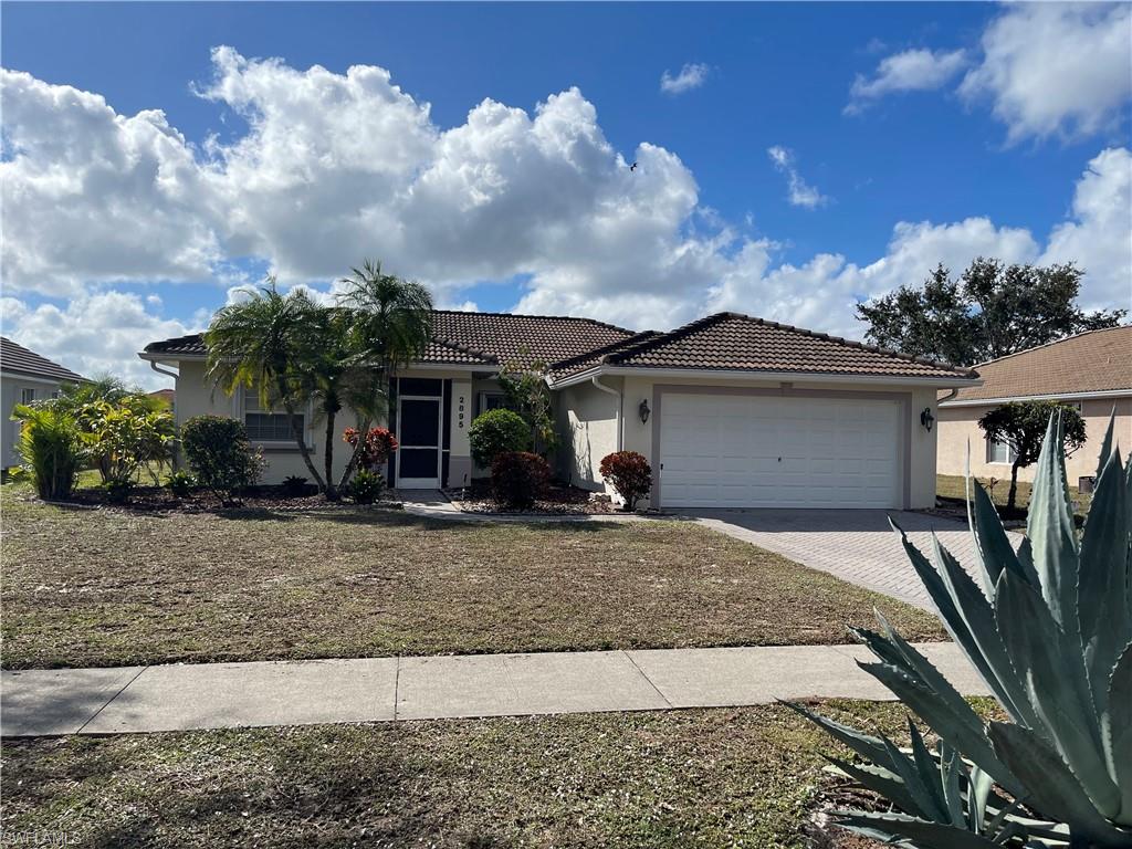 2895 Orange Grove Trail Naples, FL 34120 - Photo 2 of 33 front view of house with a yard
