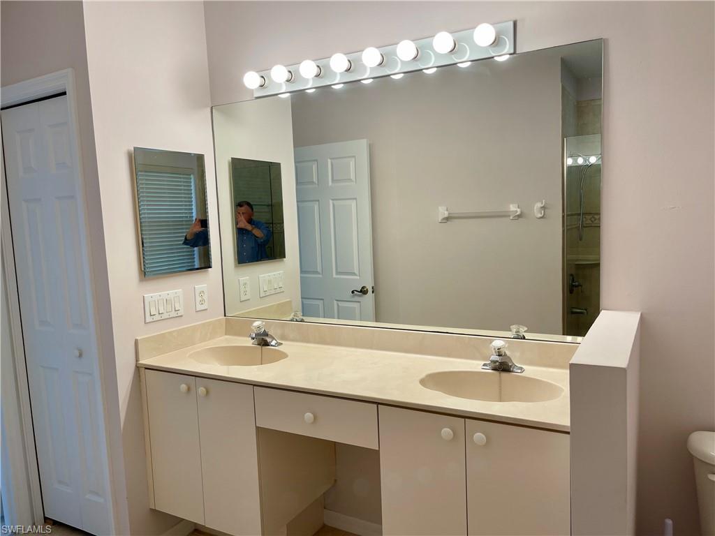 2895 Orange Grove Trail Naples, FL 34120 - Photo 23 of 33 a bathroom with a sink double vanity and a mirror