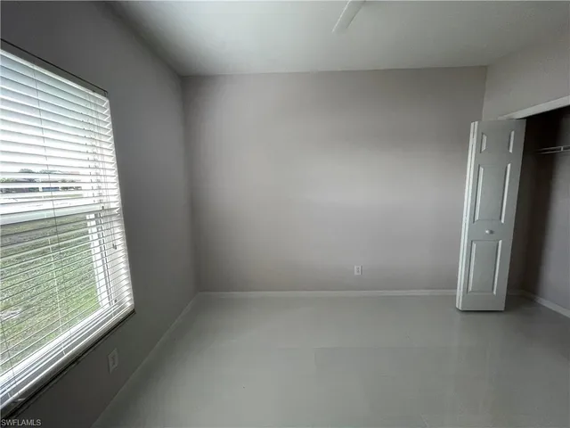 a kitchen with granite countertop a sink stove and cabinets