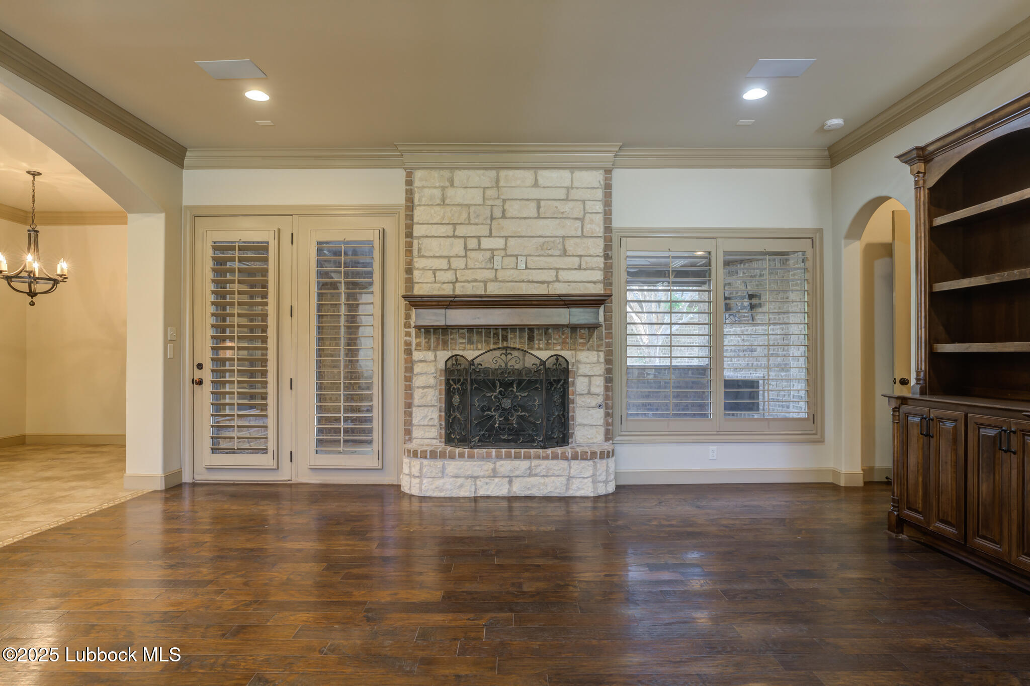 6103 89th Street Lubbock, TX 79424 - Photo 17 of 73 an empty room with wooden floor and fireplace