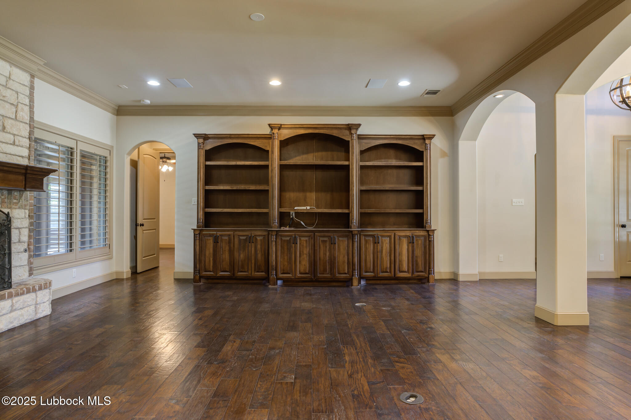 6103 89th Street Lubbock, TX 79424 - Photo 19 of 73 a view of an empty room with wooden floor and a window