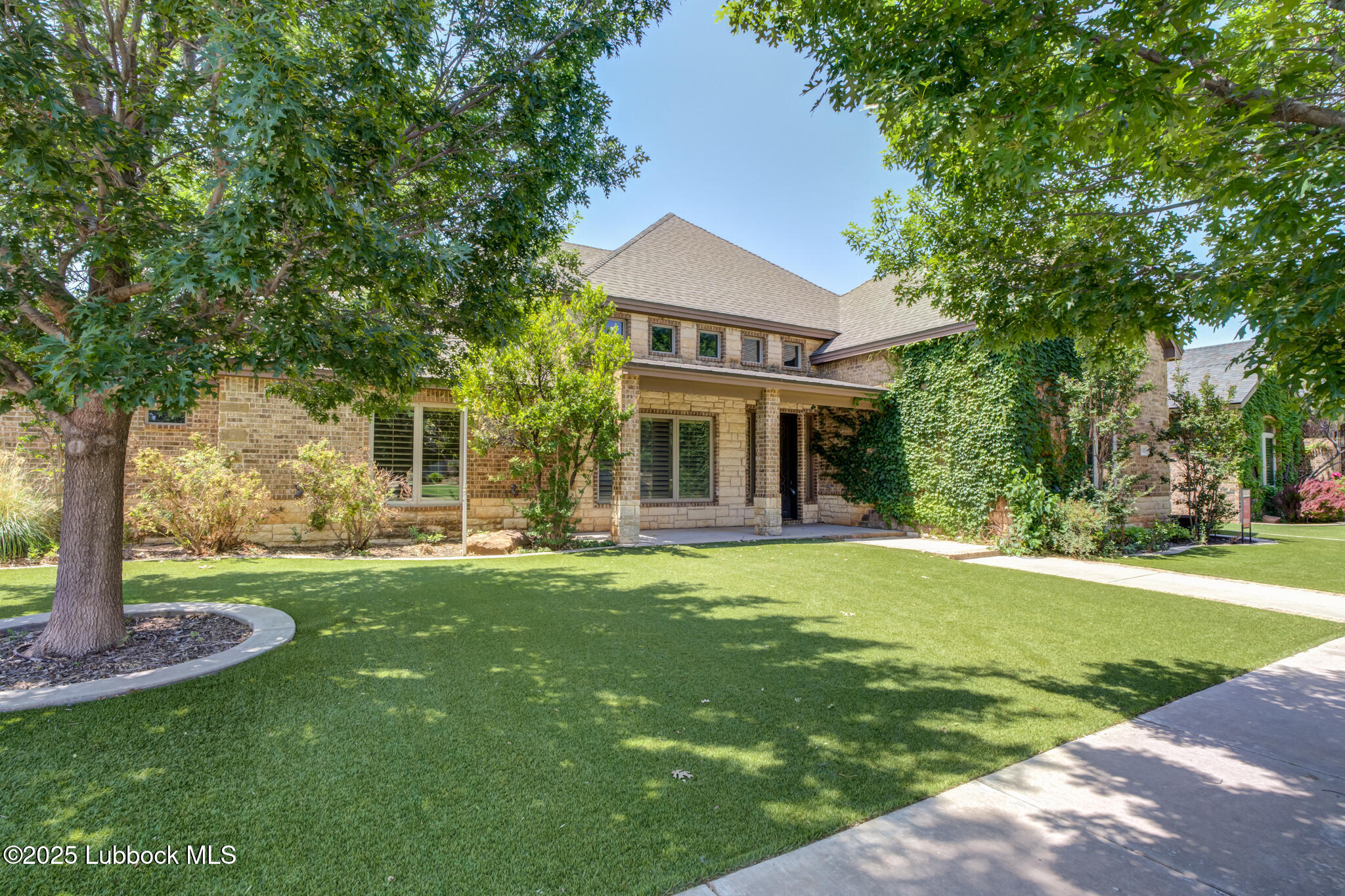 6103 89th Street Lubbock, TX 79424 - Photo 2 of 73 a front view of a house with a garden