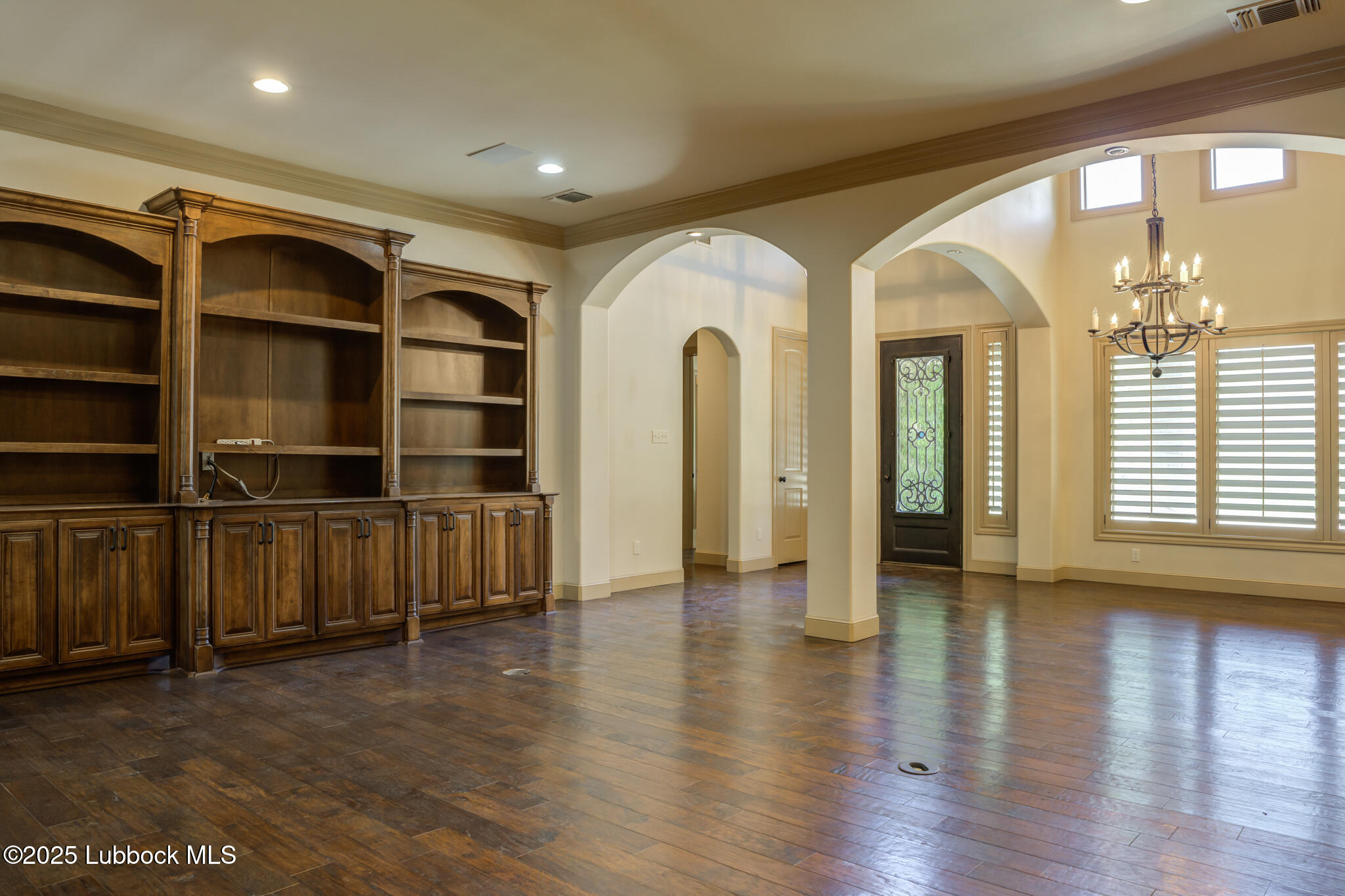 6103 89th Street Lubbock, TX 79424 - Photo 21 of 73 a view of an empty room with wooden floor and a window