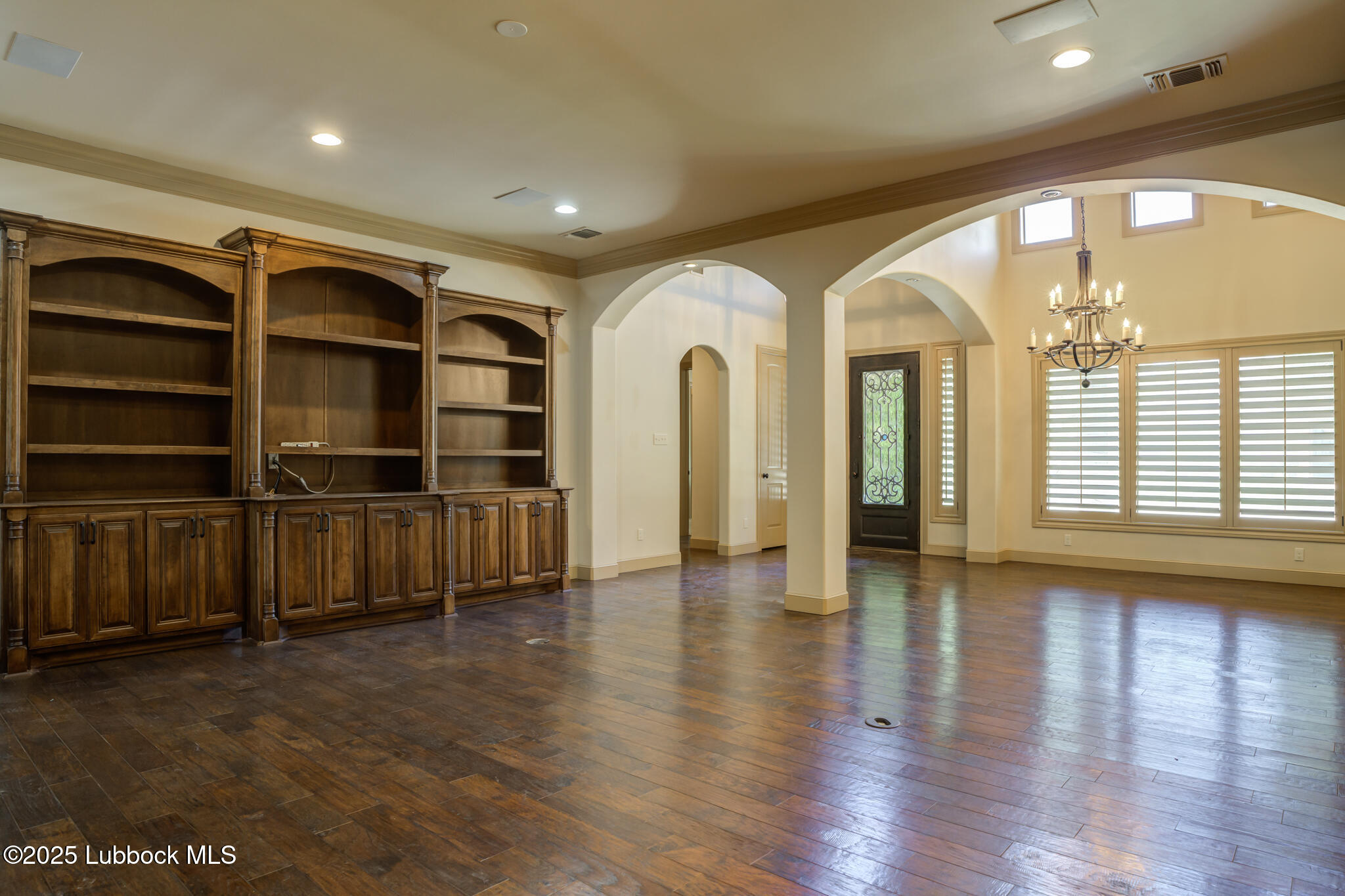 6103 89th Street Lubbock, TX 79424 - Photo 22 of 73 a view of empty room with wooden floor and windows