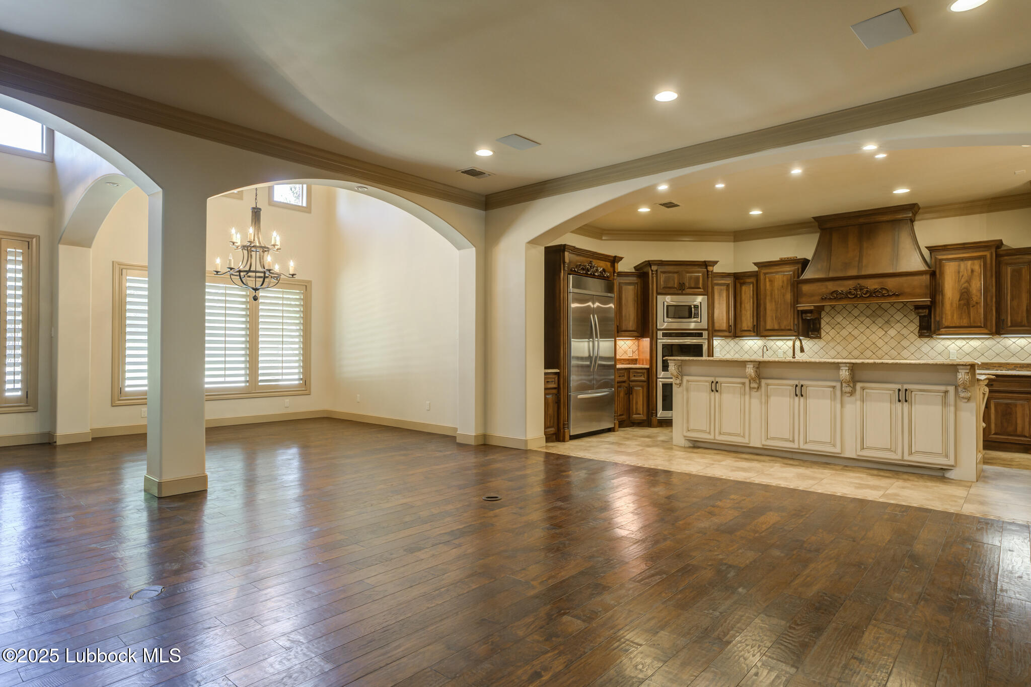 6103 89th Street Lubbock, TX 79424 - Photo 24 of 73 a view of a big room with wooden floor and windows