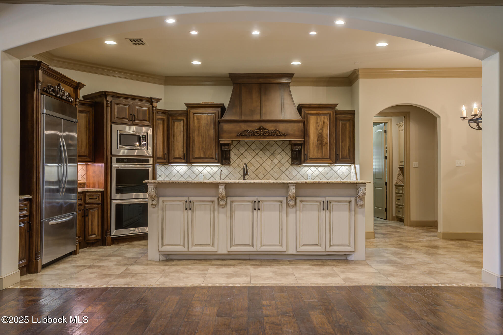 6103 89th Street Lubbock, TX 79424 - Photo 27 of 73 a view of kitchen with stainless steel appliances kitchen island granite countertop a stove and a sink
