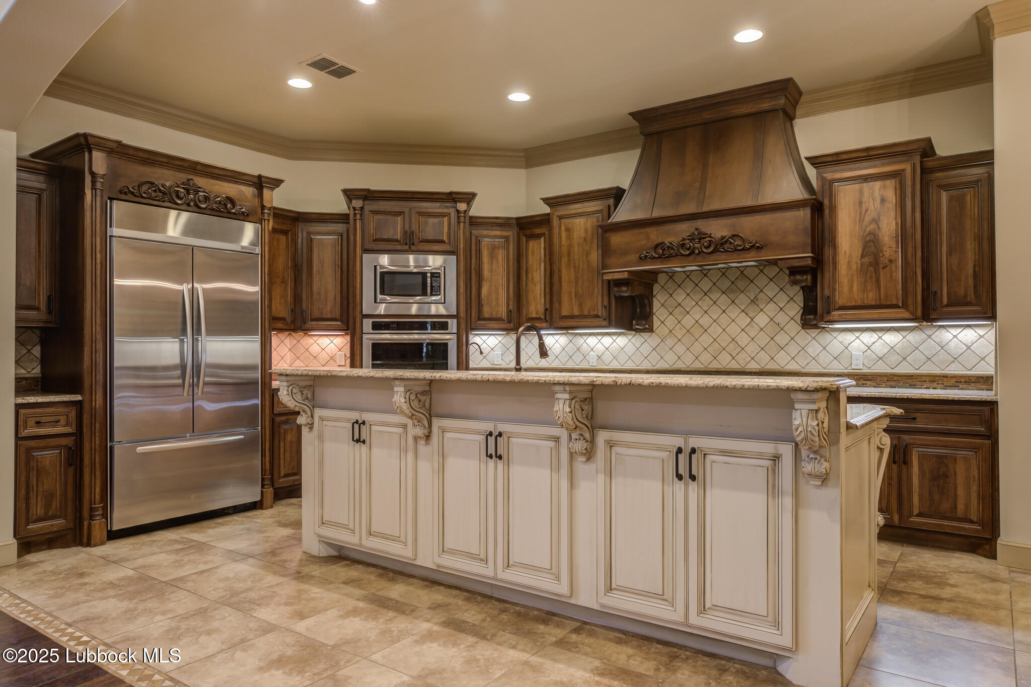 6103 89th Street Lubbock, TX 79424 - Photo 29 of 73 a kitchen with stainless steel appliances granite countertop a refrigerator and cabinets