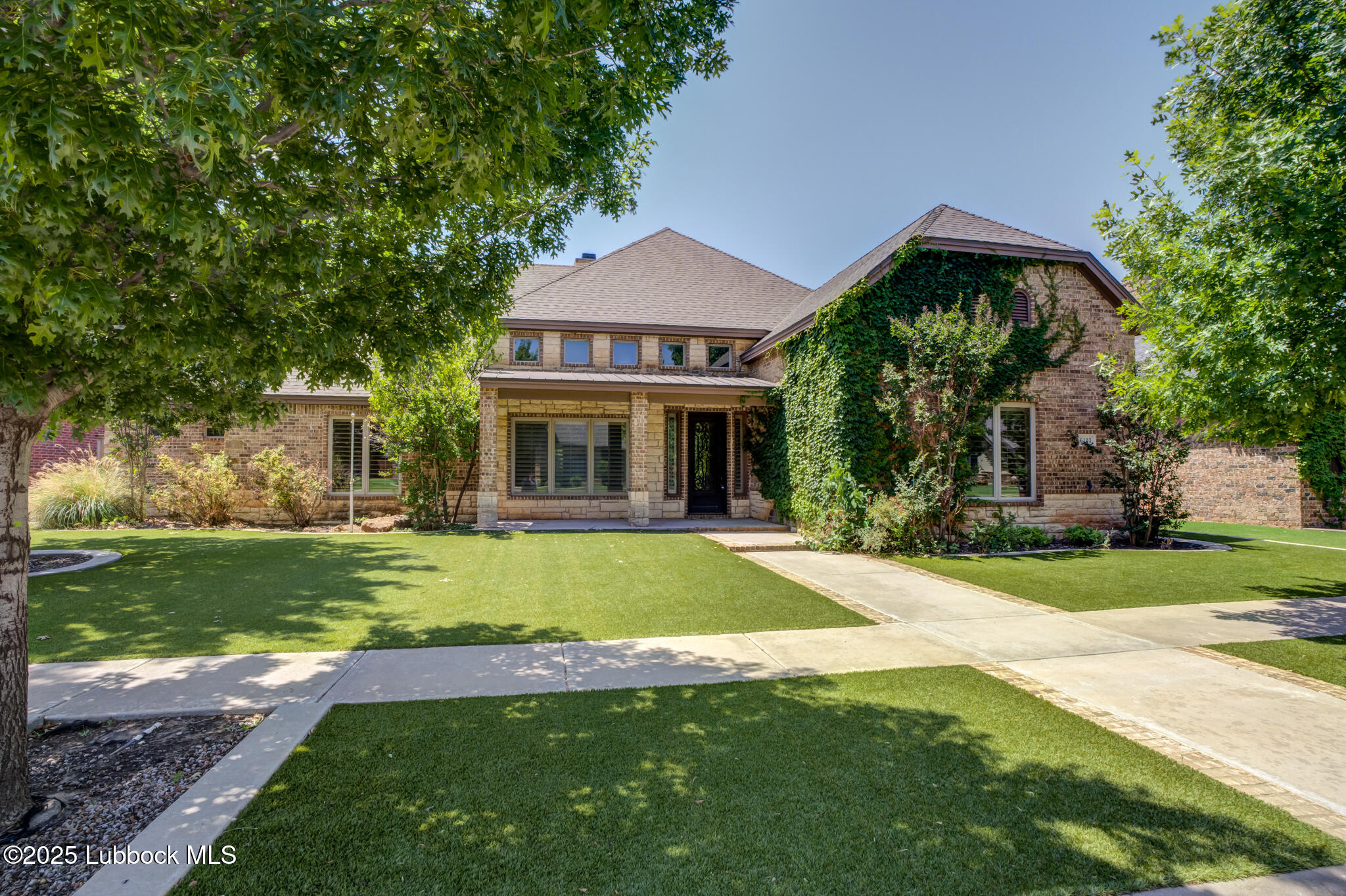 6103 89th Street Lubbock, TX 79424 - Photo 3 of 73 a front view of a house with a yard and porch