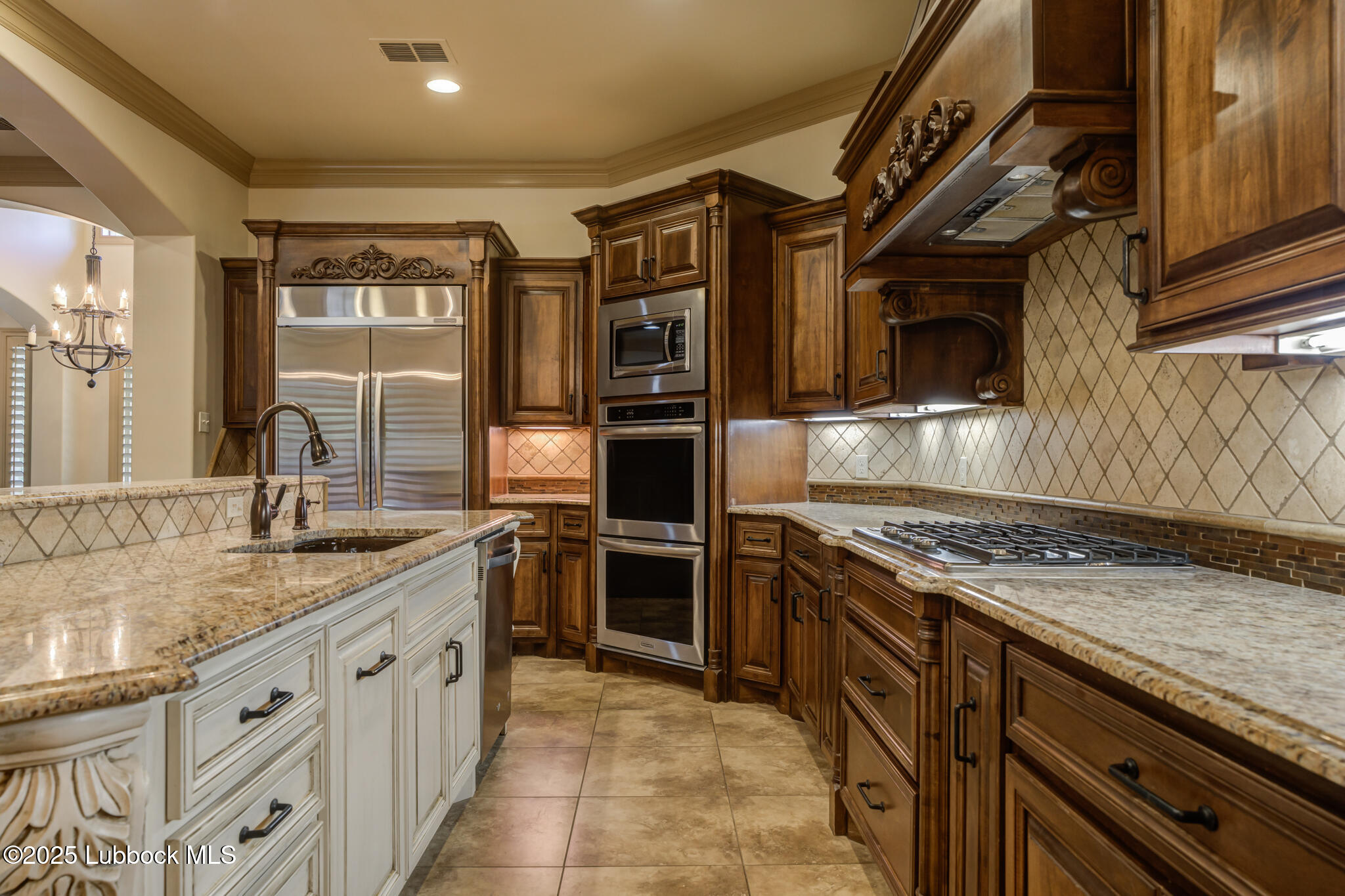 6103 89th Street Lubbock, TX 79424 - Photo 31 of 73 a kitchen with stainless steel appliances granite countertop a stove and a sink