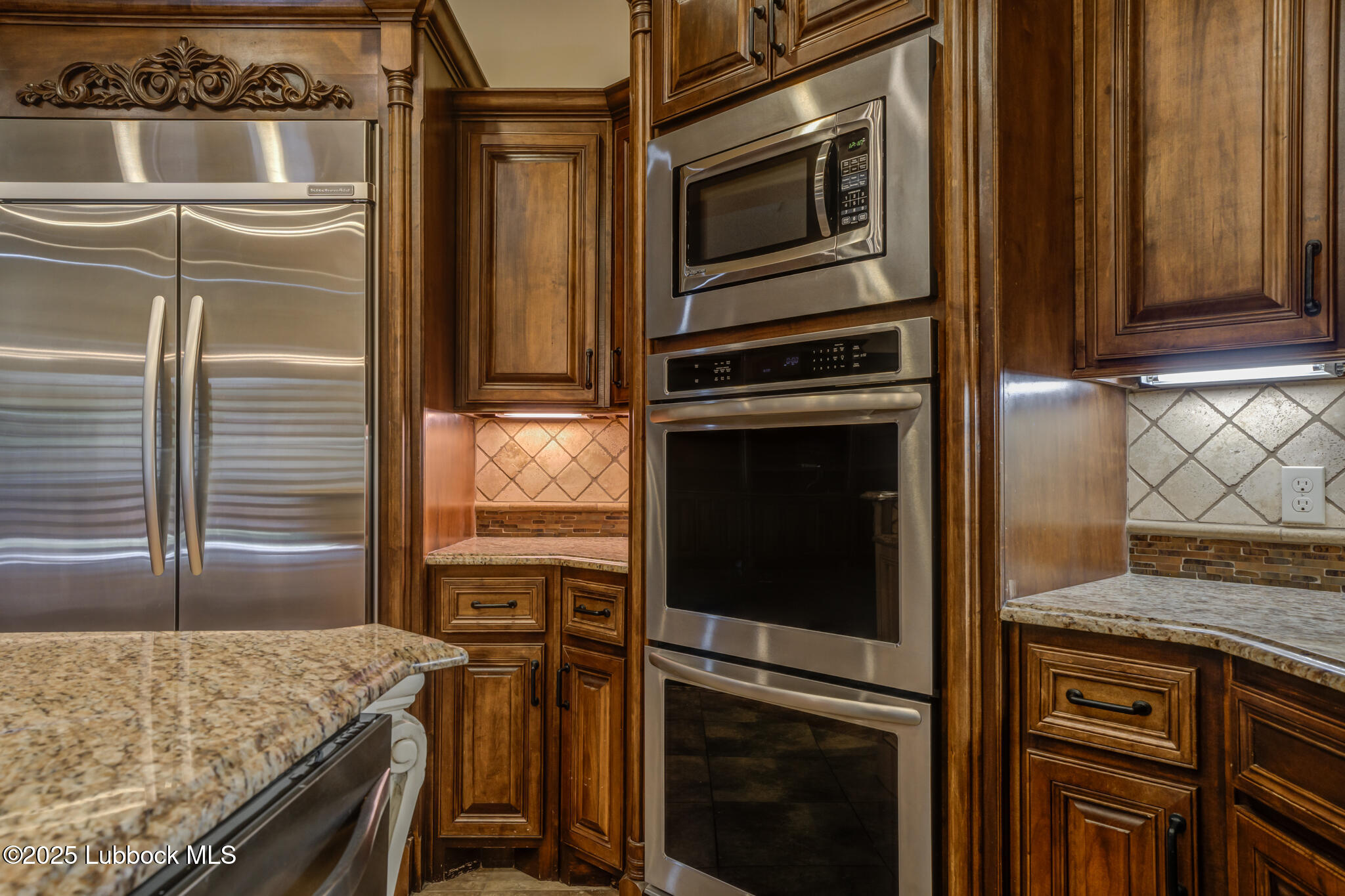 6103 89th Street Lubbock, TX 79424 - Photo 33 of 73 a kitchen with granite countertop cabinets stainless steel appliances and counter space