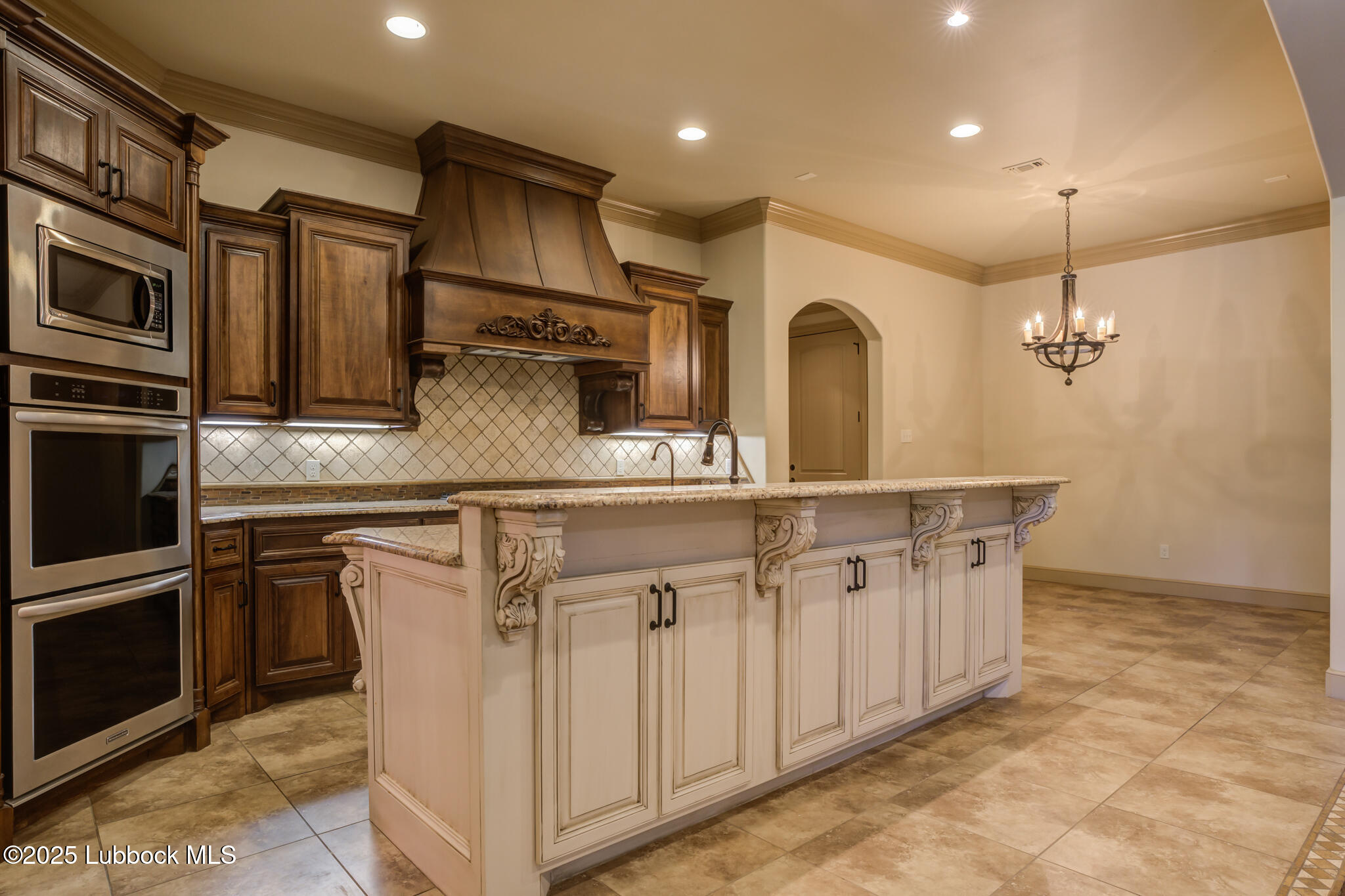 6103 89th Street Lubbock, TX 79424 - Photo 36 of 73 a kitchen with stainless steel appliances granite countertop a sink a stove and a refrigerator