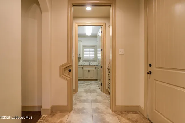 a view of an empty room with a fireplace and cabinets