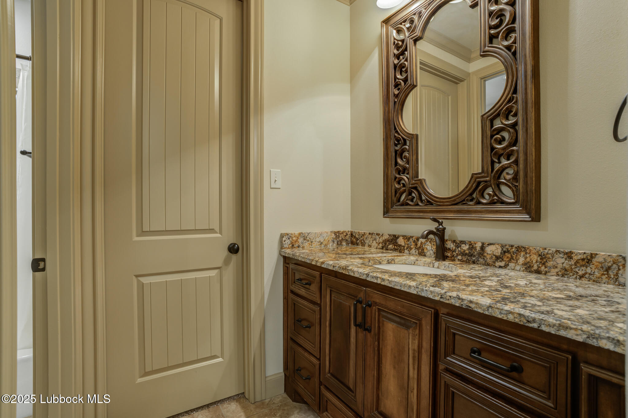 6103 89th Street Lubbock, TX 79424 - Photo 45 of 73 a bathroom with a granite countertop sink and a mirror