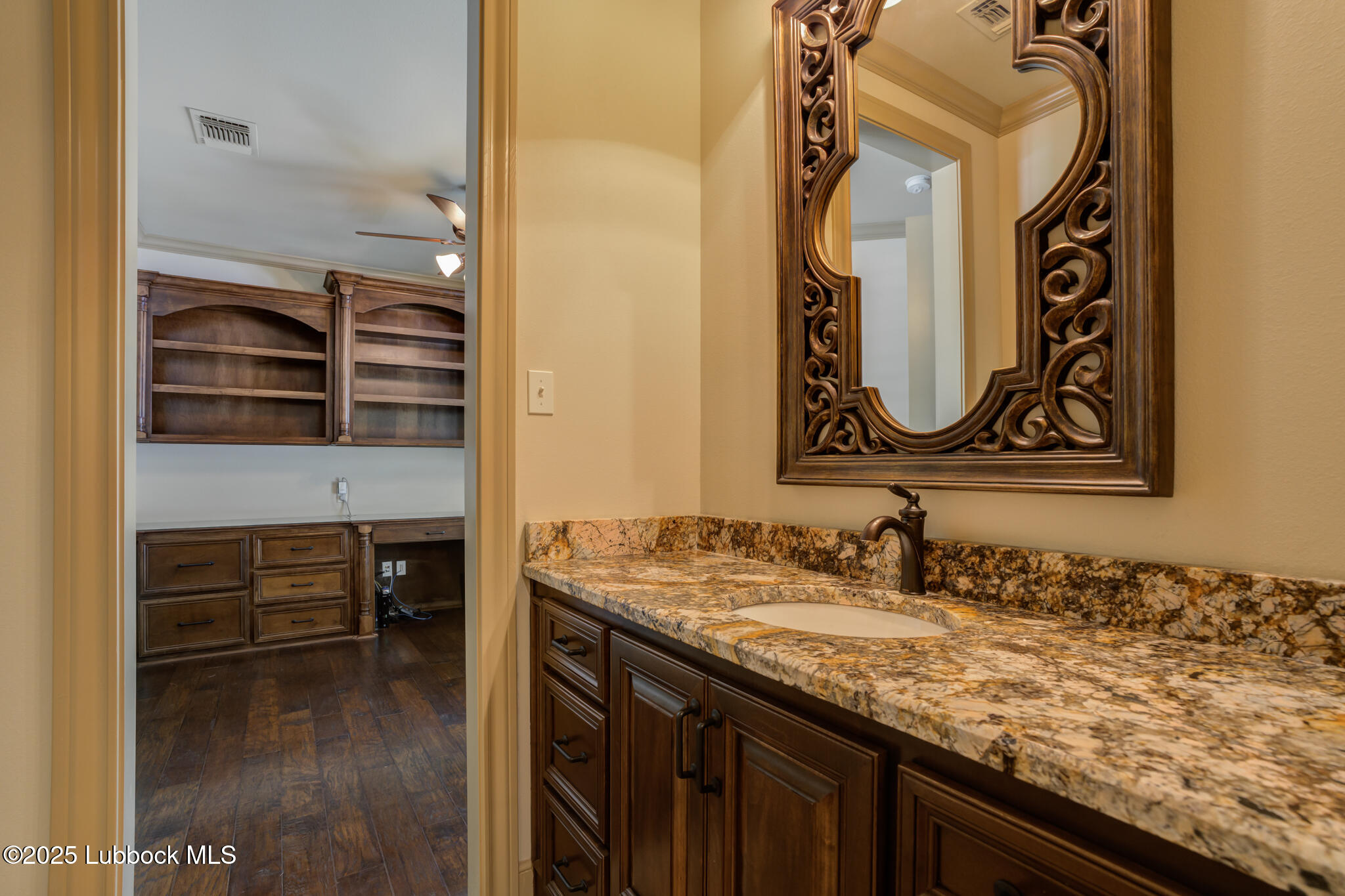 6103 89th Street Lubbock, TX 79424 - Photo 47 of 73 a bathroom with a granite countertop sink and a mirror