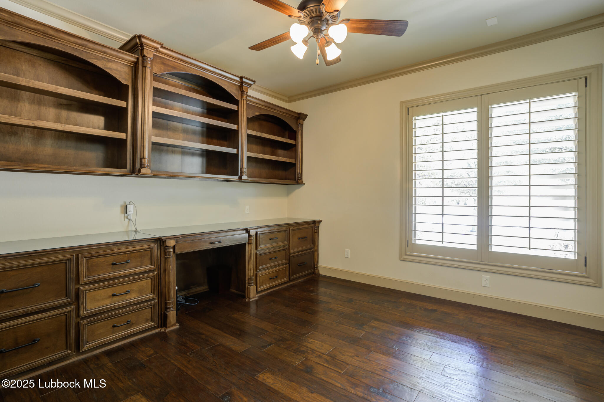 6103 89th Street Lubbock, TX 79424 - Photo 49 of 73 a kitchen with stainless steel appliances granite countertop a stove and a wooden floor