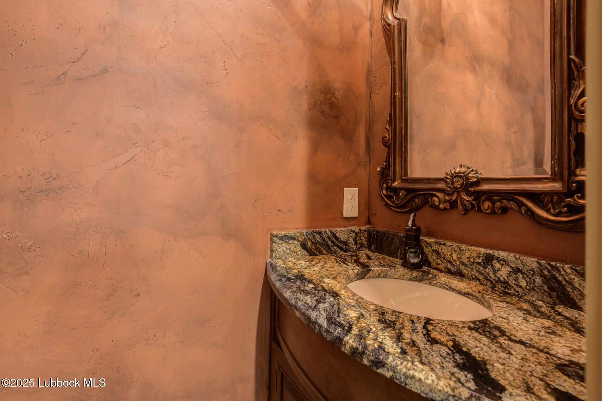 6103 89th Street Lubbock, TX 79424 - Photo 50 of 73 a bathroom with a granite countertop sink and a mirror