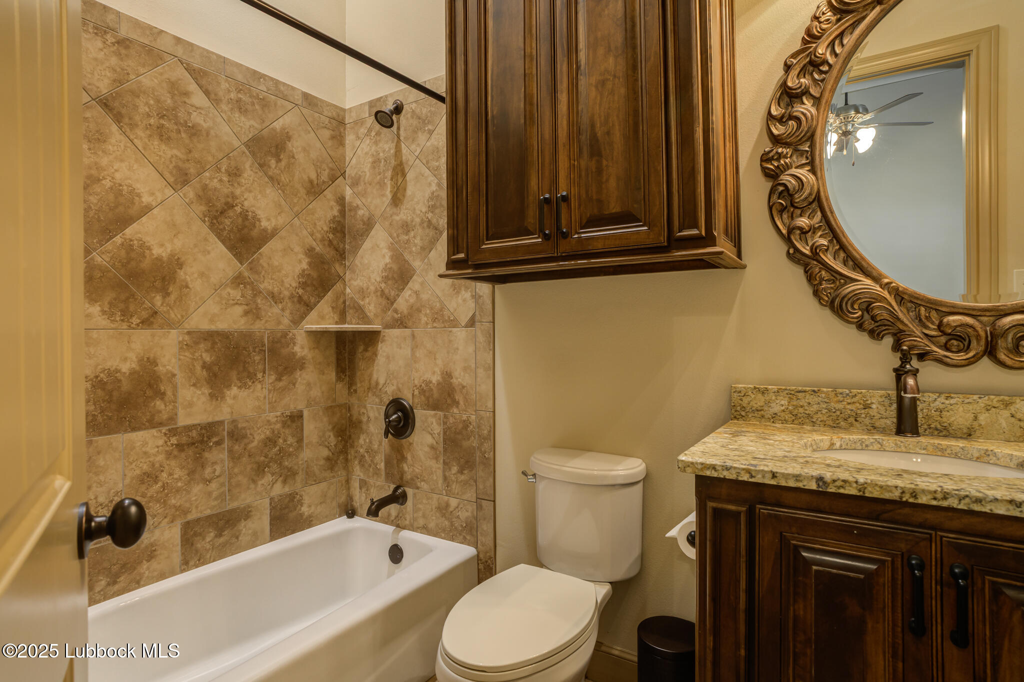 6103 89th Street Lubbock, TX 79424 - Photo 54 of 73 a bathroom with a granite countertop sink toilet and shower