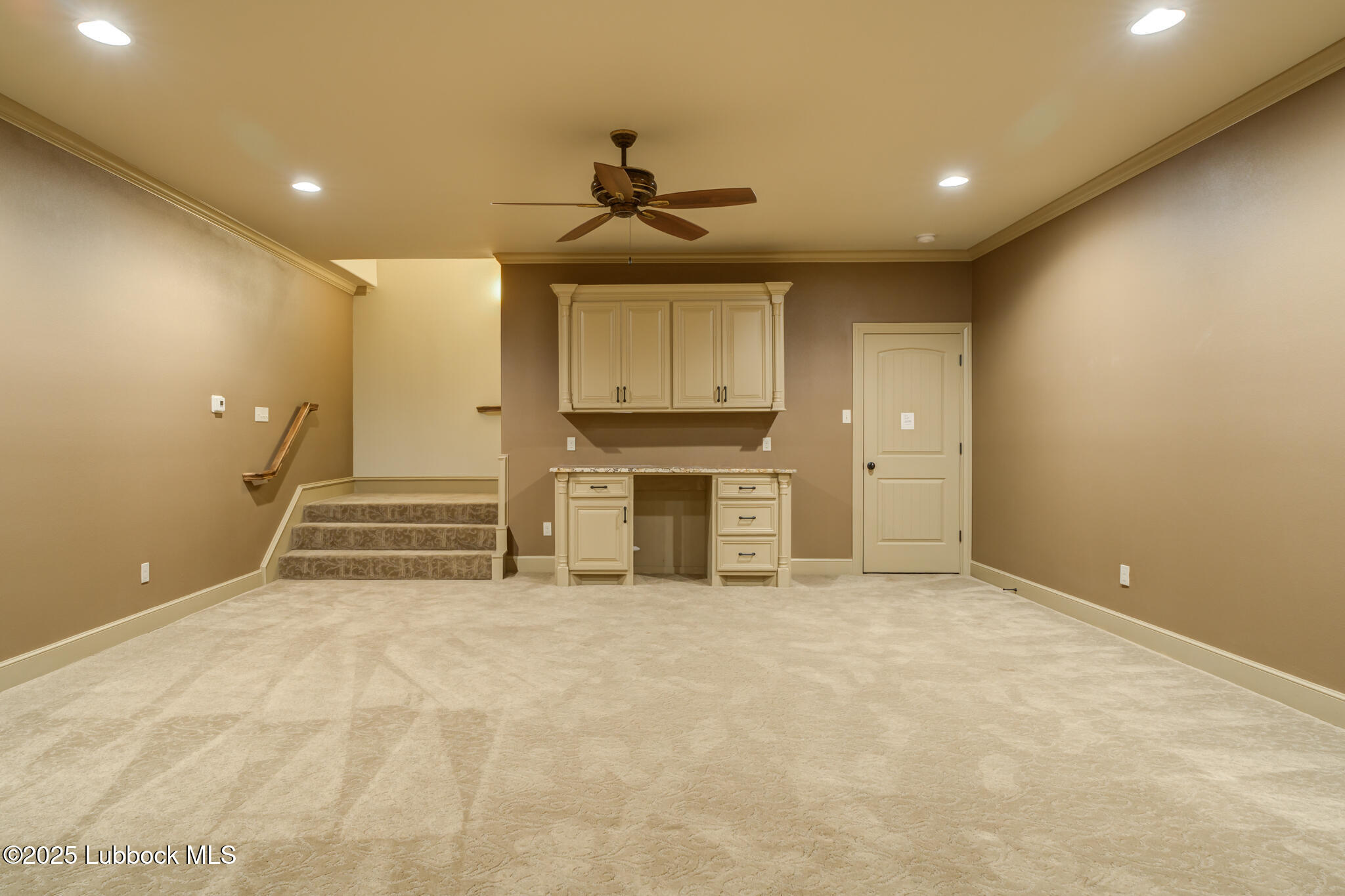 6103 89th Street Lubbock, TX 79424 - Photo 57 of 73 a view of an empty room with a fireplace and cabinets