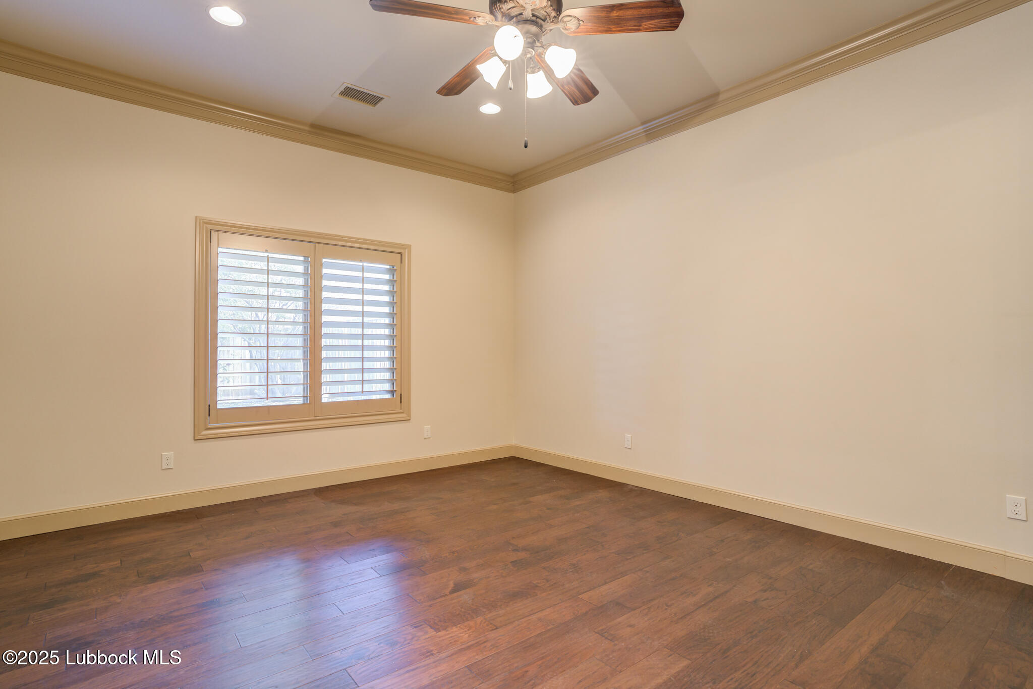 6103 89th Street Lubbock, TX 79424 - Photo 59 of 73 an empty room with wooden floor and windows