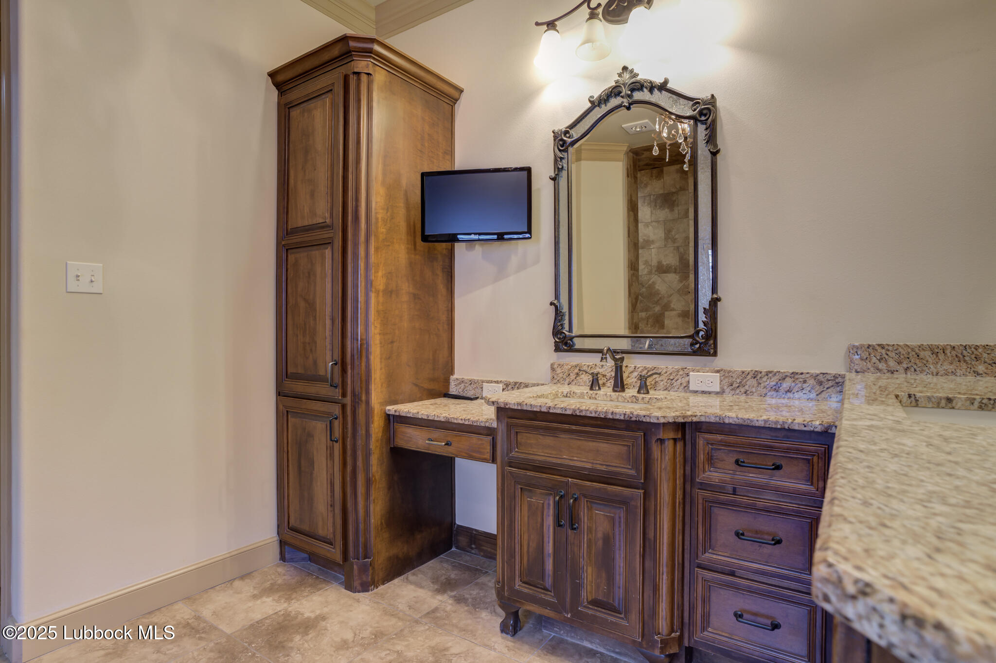 6103 89th Street Lubbock, TX 79424 - Photo 62 of 73 a bathroom with a sink and a mirror