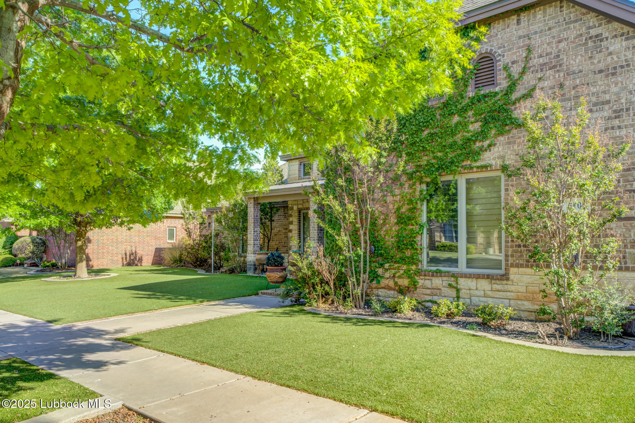 6103 89th Street Lubbock, TX 79424 - Photo 8 of 73 a front view of a house with a garden